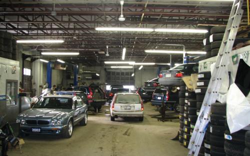 Inside shot showing a bustle of activity at 1345 Franklin’s rather large shop. In case you are wondering, the record amount of cars stored inside at one time was 25.