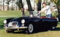 Terry Parolin posing with a 1959 MGA roadster next to Thompson Park in North Bay. At the core his business and a driver of its success, is an unbridled enthusiasm for the European automobile. Circa mid-80s.